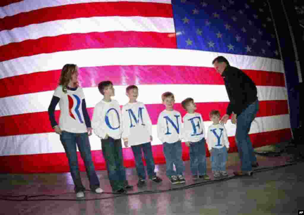Republican presidential candidate, former Massachusetts Gov. Mitt Romney, greets the Fisher family backstage prior to a campaign rally in Elko, Nev., Friday, Feb. 3, 2012.