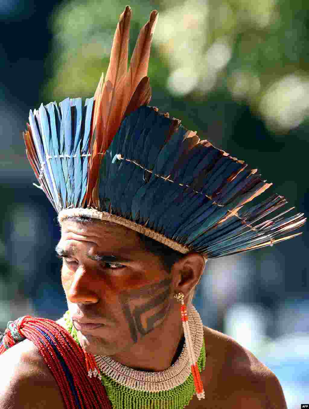 A Brazilian Munduruku native attends a rally in front of the headquarters of the National Indian Foundation in Brasilia. About 150 Mundurukus natives occupied the headquarters to demand to be consulted on the construction of the controversial Belo Monte hydroelectric.