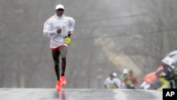 FILE - Geoffrey Kirui, of Kenya, separates himself from the pack in the men's elite division of the 122nd Boston Marathon on Monday, April 16, 2018, in Newton, Mass. (AP Photo/Steven Senne)