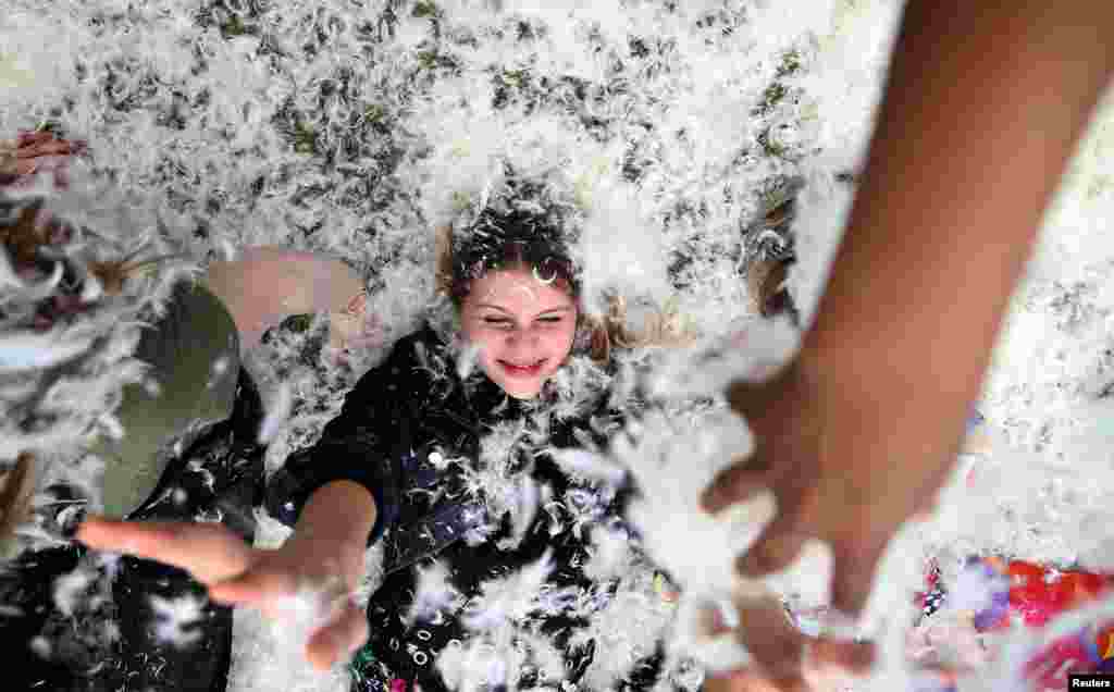 Participants take part in International Pillow Fight Day in Kennington Park in south London, Britain April 2, 2016.