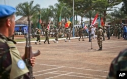 FILE - U.N. peacekeeping troops take part in a ceremony in Bangui, Central African Republic, Sept. 15. 2014. Nearly 2 dozen cases of peacekeeper-related abuse have been reported in the area.