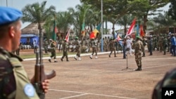 FILE - U.N. peacekeeping troops take part in a ceremony in Bangui, Central African Republic, Sept. 15. 2014. A dozen allegations of sexual misconduct have been received since the mission there was established in April 2014.