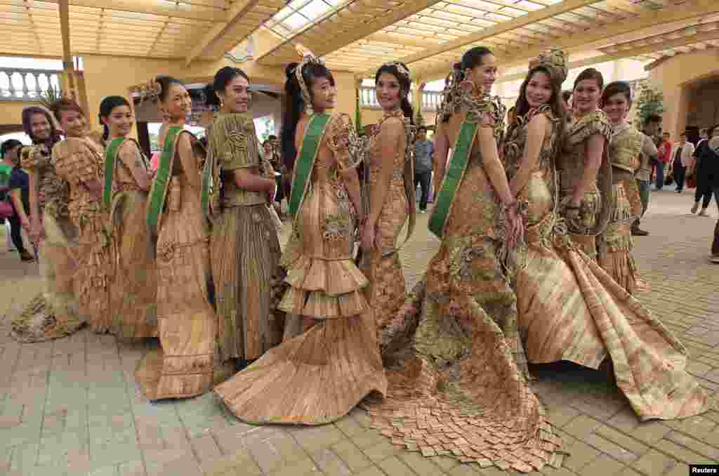 Candidates of the Miss Las Pinas Water Lily beauty pageant pose with their gowns made from dried water lilies during a media presentation in Las Pinas city, south of Manila, Philippines.