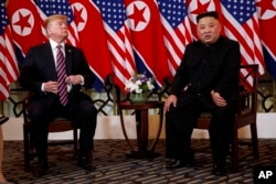 President Donald Trump listens as North Korean leader Kim Jong Un speaks during a meeting, Feb. 27, 2019, in Hanoi.