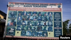 A police billboard shows a list of individuals, including the country's top militant Santoso (top L), wanted in relation with terrorism cases in Poso, Indonesia's Central Sulawesi province, Dec. 19, 2015. 