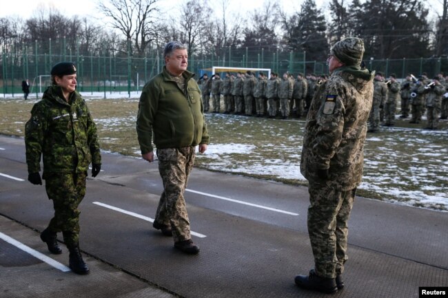 Ukrainian President Petro Poroshenko (C) and Canada's Governor General Julie Payette (L) visit the International Peacekeeping Security Center near the village of Starychy, Ukraine, Jan. 18, 2018.