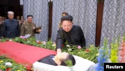 North Korean leader Kim Jong Un pays his last respects to Kim Yang Gon in this undated photo released by North Korea's Korean Central News Agency (KCNA) in Pyongyang on Dec. 31, 2015.