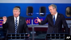 Republican presidential candidates, former Florida Gov. Jeb Bush, right, and Donald Trump both speak during the CNN Republican presidential debate at the Ronald Reagan Presidential Library and Museum on Wednesday, Sept. 16, 2015, in Simi Valley, Calif. (AP Photo/Mark J. Terrill)