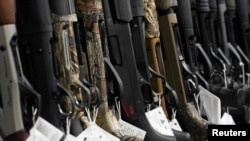 FILE - Hunting rifles are displayed for sale at Firearms Unknown, a gun store in Oceanside, California, April 12, 2021.