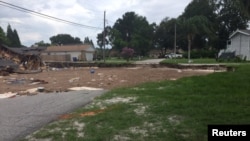 An expanding sinkhole has consumed two homes and is threatening others, north of Tampa in Pasco County, Florida, July 14, 2017.