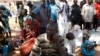 FILE - Villagers who fled the village of Gwoza, after an attack by Boko Haram in November, arrive at a camp for internally displaced people in Yola, Nigeria.