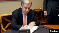 U.N. Secretary-General Antonio Guterres signs the WTO's golden book prior to the U.N. Secretary-General addressing to Special Session of the WTO's General Council, in Geneva, Switzerland, May 10, 2019. 