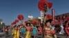 Dancers participate in the Chinatown's 119th annual Golden Dragon Parade to celebrate the Year of the Dog, with firecrackers, dragon, floats and bands in Los Angeles, Feb. 17, 2018. 
