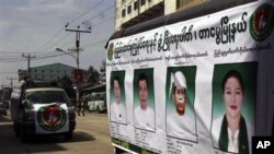 Members of the Union Solidarity and Development Party drive a campaign vehicle with posters of the party's candidates who ran in the November 7, 2010 general elections.