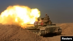 Members of the Iraqi Army fire at Islamic State militant positions in the south of Mosul, Iraq, Dec. 10, 2016. Many U.S. officials believe IS intends to use any and all tactics at its disposal to turn Iraq's second largest city into "hell on earth.”