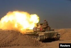 Members of the Iraqi Army fire towards Islamic State militant positions at the south of Mosul, Iraq, Dec. 10, 2016.