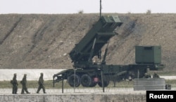 Japanese Self-Defence Force's soldiers are seen next to a Patriot missile system on the Japanese southern island of Ishigaki, Okinawa Feb. 7, 2016.