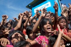 Rohingya refugee children shout slogans during a protest against the repatriation process at Unchiprang refugee camp near Cox's Bazar, in Bangladesh, Nov. 15, 2018.