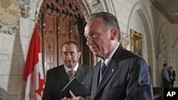 Canada's Environment Minister Peter Kent leaves after announcing that Canada will formally withdraw from the Kyoto protocol on climate change, on Parliament Hill in Ottawa, December 12, 2011.