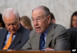 Senate Judiciary Committee Chairman Chuck Grassley, R-Iowa, joined by Sen. Orrin Hatch, R-Utah, left, opens a hearing on the Trump administration's policies on immigration enforcement and family reunification efforts, on Capitol Hill in Washington, July 31, 2018.