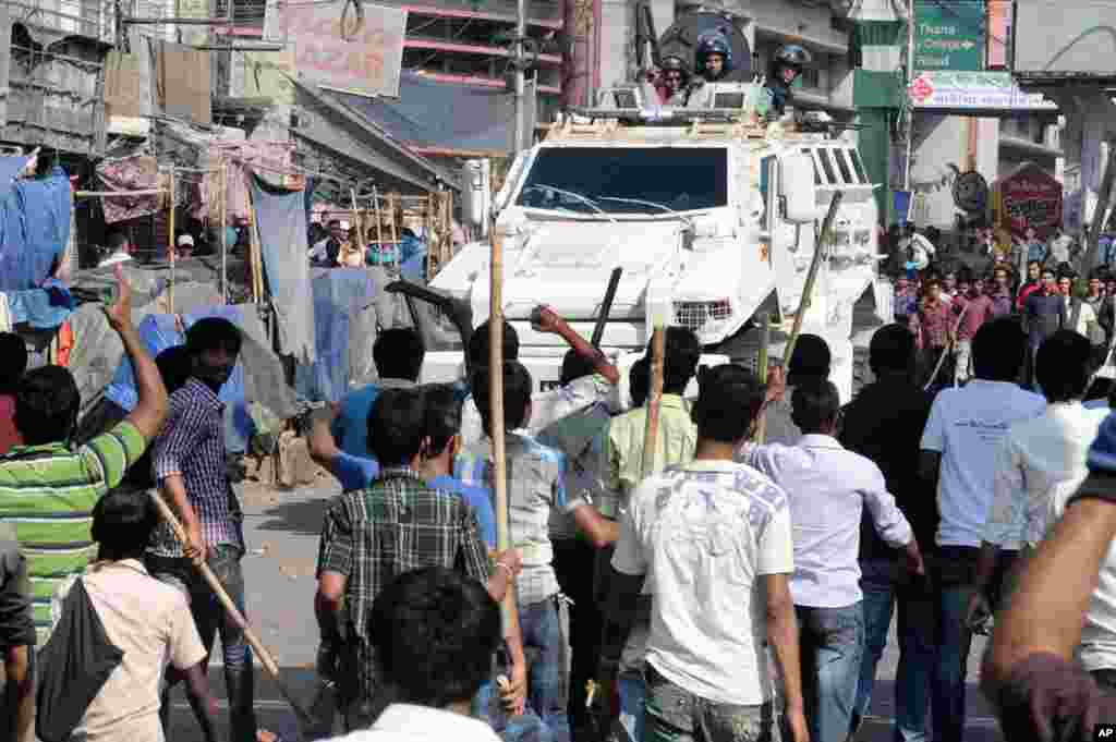 Members of Islamic party Jamaat-e-Islami attack a security vehicle during a strike called by the party in Chittagong, Bangladesh, Feb. 28, 2013.