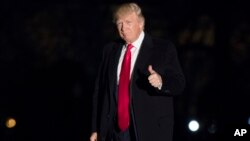 President Donald Trump gives a thumbs up to members of the media as he arrives at the White House in Washington, Feb. 20, 2017. 