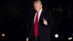 President Donald Trump gives a thumbs up to members of the media as he arrives at the White House in Washington, Feb. 20, 2017. 