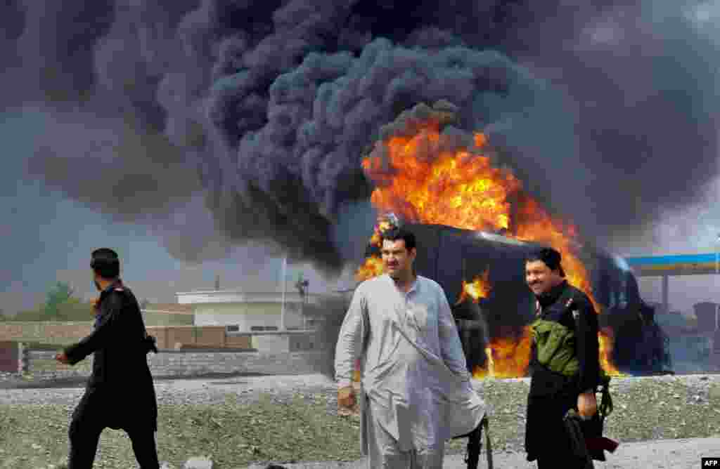 Pakistani security personnel are seen near a burning NATO supply oil tanker following an attack at Sor Kamar in the Khyber tribal district, some 25 kilometers west of Peshawar. At least two people were killed when gunmen in northwest Pakistan opened fire on tankers carrying fuel for NATO troops in Afghanistan.