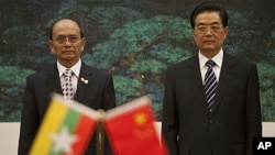 Burma's President Thein Sein, left, and Chinese President Hu Jintao watch a signing ceremony at the Great Hall of the People in Beijing, China, May 27, 2011.