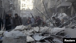 Residents inspect damage after airstrikes by Syrian government forces in the rebel-held Al-Shaar neighborhood of Aleppo, Syria, Feb. 4, 2016. 