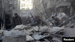 Residents inspect damage after airstrikes by Syrian government forces in the rebel-held Al-Shaar neighborhood of Aleppo, Syria, Feb. 4, 2016.