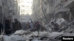 Residents inspect damage after airstrikes by pro-Syrian government forces in the rebel held Al-Shaar neighborhood of Aleppo, Syria, Feb. 4, 2016. 