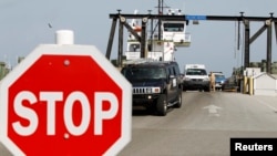 FILE - People arrive at Cape Hatteras ferry terminal in North Carolina, Aug. 25, 2011. The ferry is the only access to Ocracoke Island, which along with Hatteras is welcoming tourists back now that electricity has been restored.