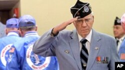 Korean War veterans stand and salutes the casket of Artie Hodapp, during funeral services in Freeport, Ill., Wednesday, May 25, 2011. More than half a century after he died in Korea, the bones of the young soldier, Artie Hodapp, are returned after being m