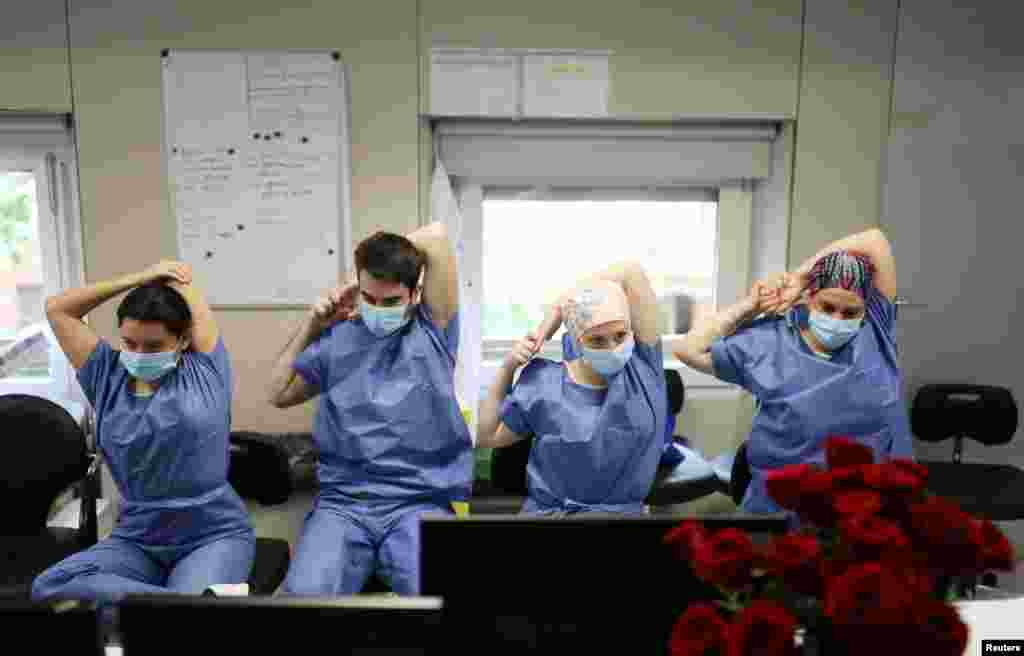 Hospital medical workers do yoga stretches and breathing exercises in the Intensive Care Unit at the Hospital Clinic in Barcelona, Spain.