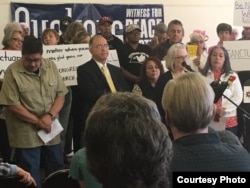 Emma, standing behind speaker to the left, is seeking sanctuary in Albuquerque, New Mexico.