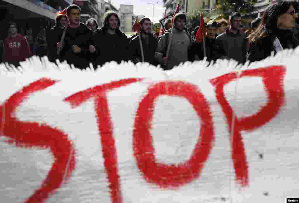 Protesters march during an anti-racism rally against the new headquarters of the extreme-right Golden Dawn party in Athens, Greece.