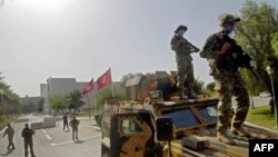 Tunisian military forces guard the area around the parliament building in the capital Tunis on July 26, 2021, following protests in reaction to a move by the president last night to suspend the north African country's parliament and dismiss the Prime Mini