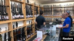 FILE - Firearms and accessories are on display at Gun City gunshop in Christchurch, New Zealand, March 19, 2019. New Zealand toughened its gun laws after a mass shooting at two mosques in Christchurch.