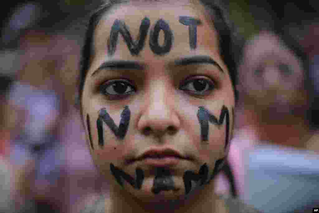 A participant is seen during a protest against two recently reported rape cases near the Parliament in New Delhi, India.