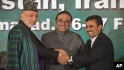 Presidents from Afghanistan, Hamid Karzai (L), Pakistan's Asif Ali Zardari (C) and Iran's Mahmoud Ahmadinejad join hands as they pose for pictures after a news conference in the President House in Islamabad, Feb. 17, 2012.