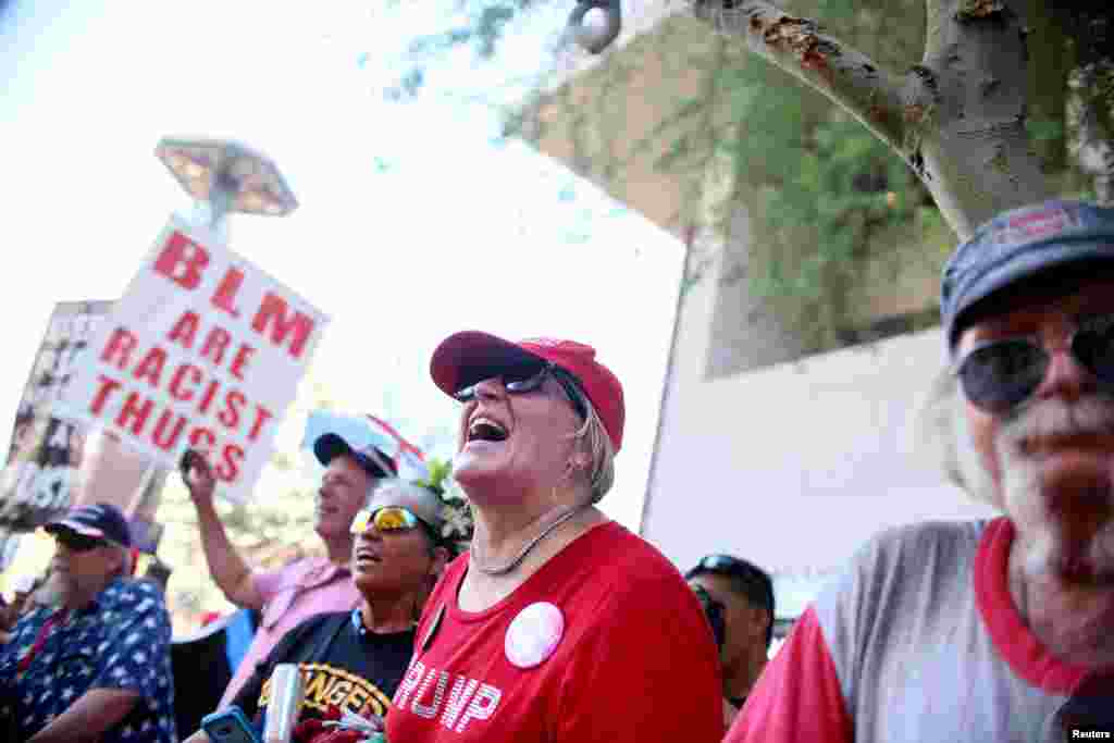 Pro Trump supporters face off with peace activists during protests outside a Donald Trump campaign rally in Phoenix, Ariz., Aug. 22, 2017.