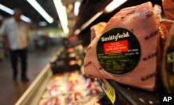 FILE - In this Sept. 6, 2011 file photo, shows a Smithfield ham at a grocery store in Richardson, Texas.