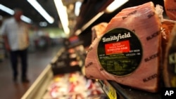FILE - A Smithfield ham is seen in a grocery store in Richardson, Texas. Chinese meat processor Shuanghui International Holdings Ltd. agreed Wednesday, May 29, 2013, to buy Smithfield Foods Inc. for approximately $4.72 billion.