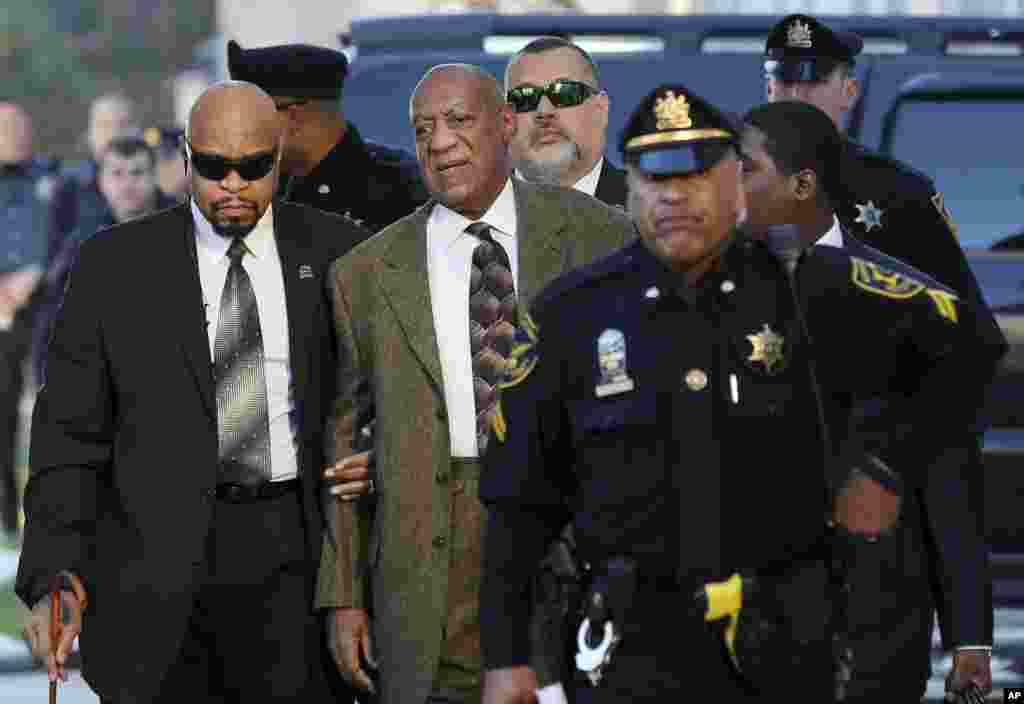 Actor and comedian Bill Cosby, center, arrives for a court appearance in Norristown, Pansylvania. Cosby was arrested and charged with drugging and sexually assaulting a woman at his home in January 2004.