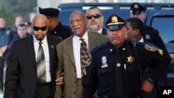 Actor and comedian Bill Cosby, center, arrives for a court appearance Tuesday, Feb. 2, 2016, in Norristown, Pa. Cosby was arrested and charged with drugging and sexually assaulting a woman at his home in January 2004. 
