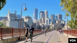 Minnesota state Rep. Esther Agbaje’s district includes downtown Minneapolis, shown from the Stone Arch Bridge that spans the Mississippi River. (Carol Guensburg/VOA)