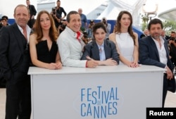 (L-R) Cast members Christian Gregori, Jessica Erickson, Richard Chevallier, Heloise Godet, Zoe Bruneau and Kamel Abdelli pose during a photocall for the film "Adieu au langage" (Goodbye to Language) in competition at the 67th Cannes Film Festival in Cannes, May 21, 2014.