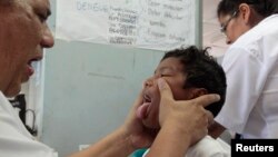 FILE - A dengue fever victim receives medical treatment at a health center in Managua, Oct. 31, 2013. Hemorrhagic dengue was responsible for 14 deaths in Nicaragua so far this year, with the number of cases confirmed at more than five thousand, according 