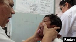 FILE - A dengue fever victim receives medical treatment at a health center in Managua, Nicaragua, Oct. 31, 2013. 